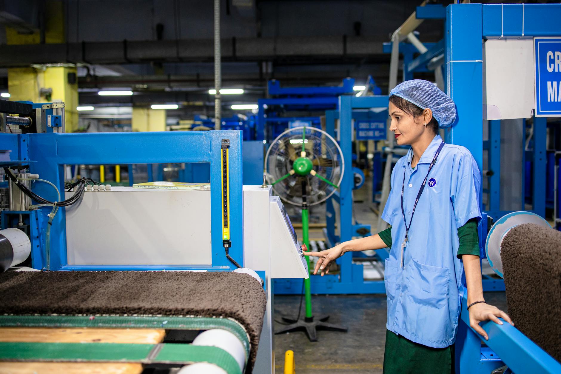 Modern factory worker managing machinery